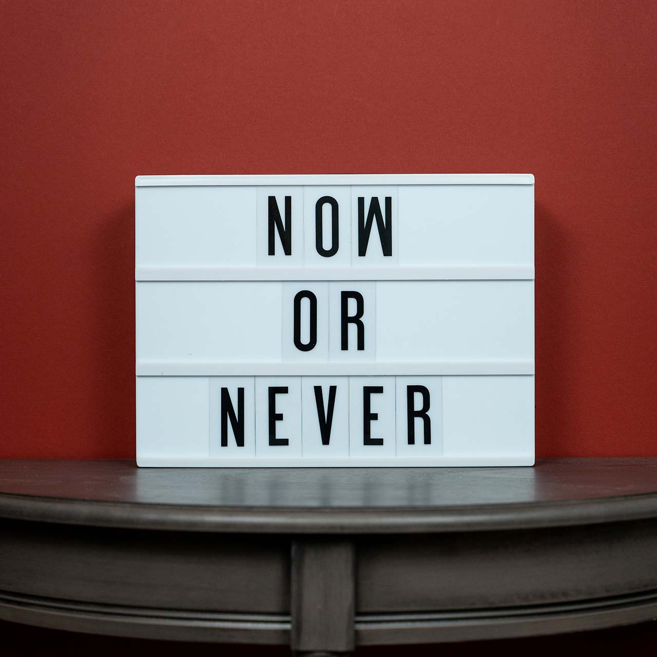 Photo of a lightbox with letters spelling Now or Never