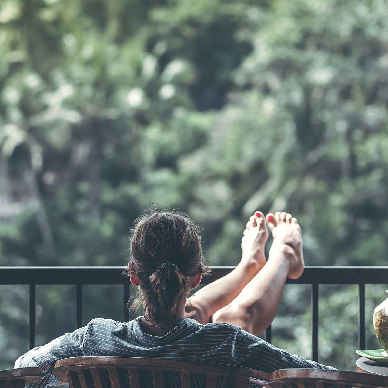 Photo of a woman relaxing on a balcony