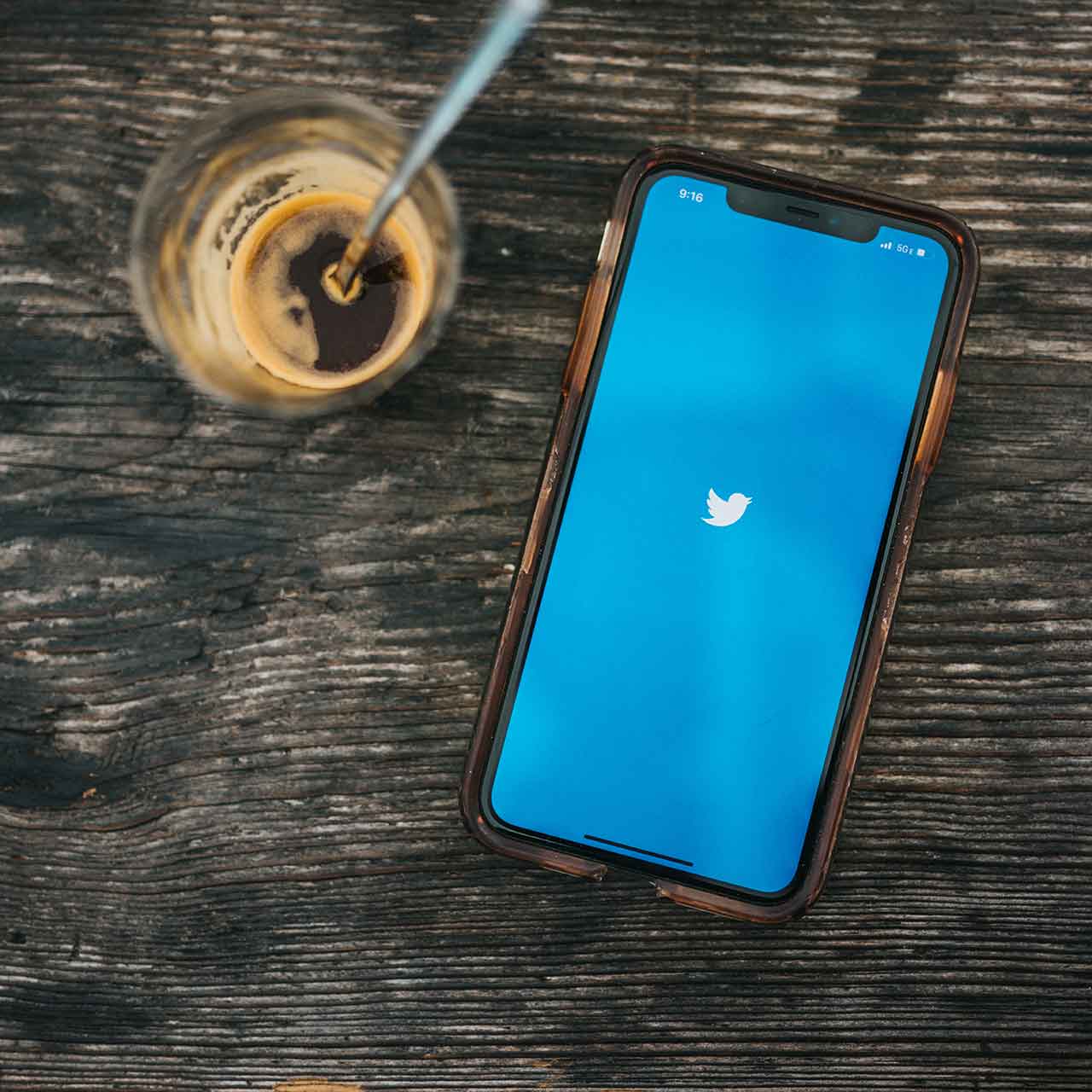 Photo of a smartphone with a Twitter logo on the screen